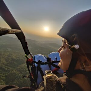 Woman On Tandem Paragliding Flight At Sunset In Bir Billing