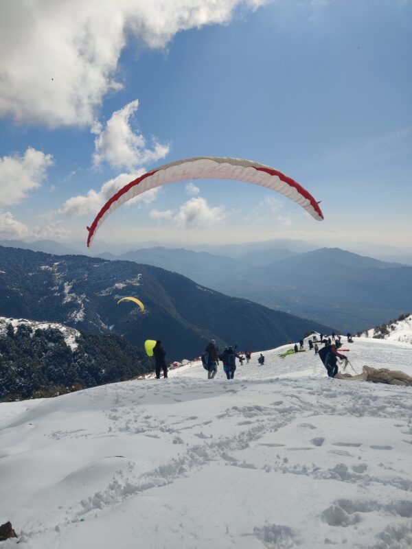 Paragliding In Winter With Snow-Covered Peaks And Clear Blue Skies Bir Billing